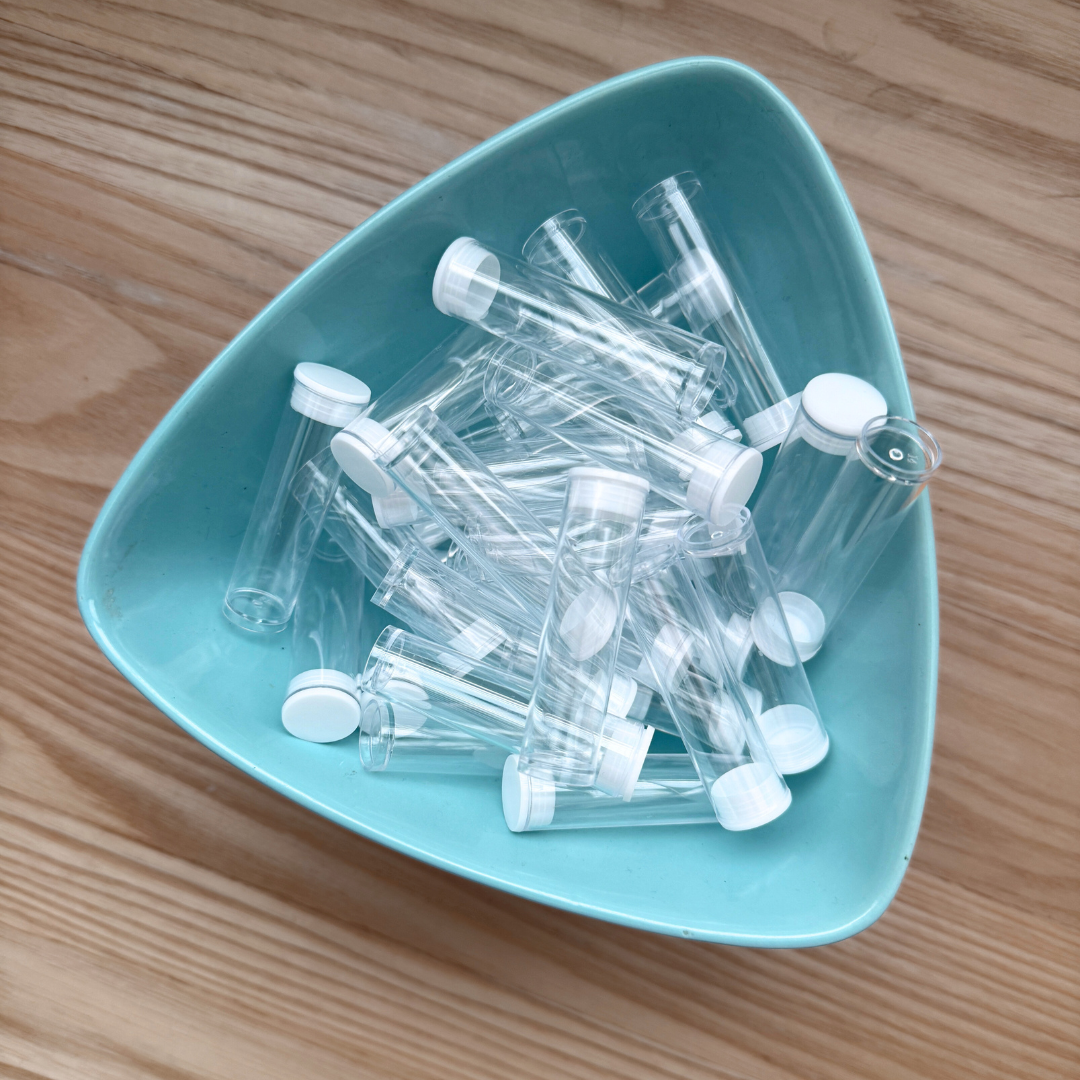 Clear plastic bead tubes with lids, in a blue bowl