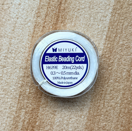 Close up of spool with text: 
MIYUKI Elastic Beading Cord
H639E 20m(22yds.)
0.3 ~ 0.5 mm dia.
100% Polyurethane
Made in Japan